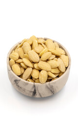 Peeled almond kernel isolated on white background. A bowl of almonds. close up