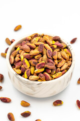 Pistachio kernel isolated on white background. A bowl of pistachios. close up