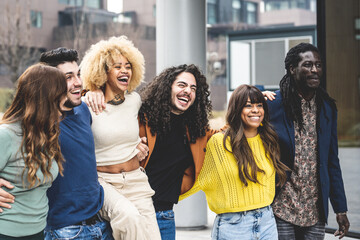 multiracial group of friends walking and having fun together, millennials people smiling and laughing in city context, social diversity people from the world