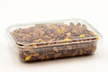 Packed pistachios on a white background. Pistachios packaged for sale at the market counter. close up