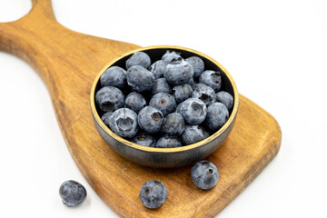 Blueberry isolated on white background. Blueberries in the bowl. Close-up.