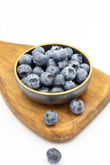 Blueberry isolated on white background. Blueberries in the bowl. Close-up.