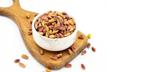 Pistachio kernel isolated on white background. A bowl of pistachios. close up. Copy space. Space for text