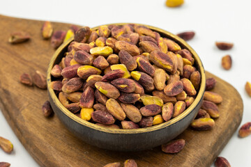 Pistachio kernel isolated on white background. A bowl of pistachios. close up.