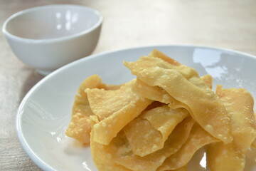 crispy fried dumpling paste stuffed chop pork dipping sweet chili sauce on plate