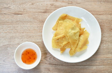 crispy fried dumpling paste stuffed chop pork dipping sweet chili sauce on plate