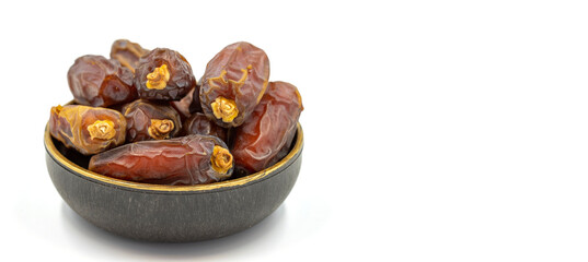 Date fruit isolated on a white background. A bowl of date fruit (Medjoul). close up. Copy space. Space for text
