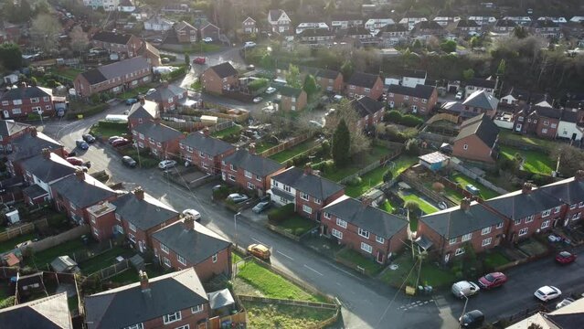 Generic view of a British street of houses with moving car