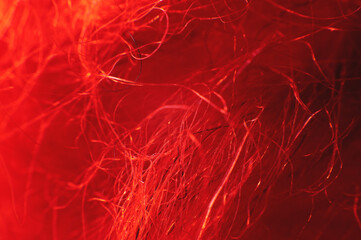 Macro photo. Close-up abstract textile fiber red-orange color extreme macro in shallow depth of field. Abstract background