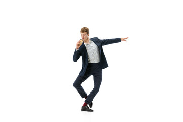 Man in office style clothes dancing with coffee to go isolated on white studio background. Business, start-up, open-space, inspiration concept.