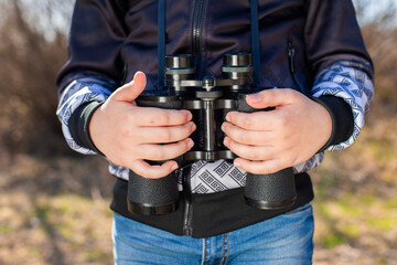 Fototapeta premium binoculars in the hands of a child