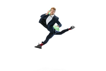 Fototapeta na wymiar Portrait of flexible man in business style clothes dancing isolated on white studio background. Business, start-up, open-space, inspiration concept.