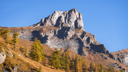 The mountains of the Lepontine Alps and the woods during a beautiful Autumn day, near the village of San Domenico di Varzo, Piedmont, Italy - October 2021.