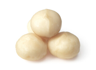 Unshelled macadamia nuts isolated on white background.