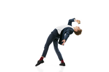 Studio shot of young male ballet dancer wearing business suit dancing isolated on white studio background. Business, start-up, art, work, caree, inspiration concept.