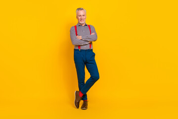 Fototapeta na wymiar Full length body size view of attractive cheerful man mc folded arms isolated over vibrant yellow color background