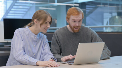 Naklejka na ściany i meble Young Man and Woman Celebrating Success on Laptop 