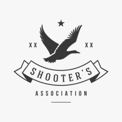 Hunters association with flying duck silhouette vector logo. Organization logotype well aimed shooters for extraction birds. Enviable monochrome trophy indicator of shooting skill