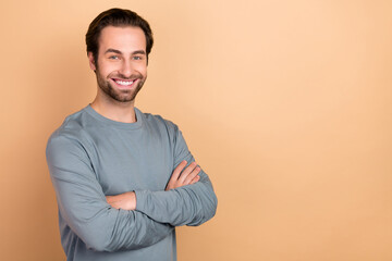 Photo of young man cheerful man smart crossed hands agent leader isolated over beige color background