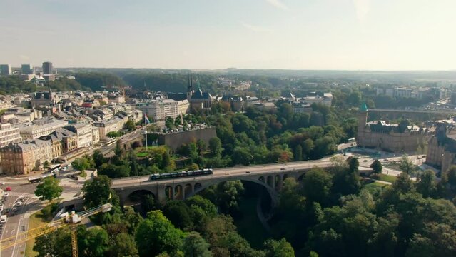 Establishing Aerial view of Luxembourg City Panorama with Landmark Adolphe Bridge, Park, Plateau Bourbon Architecture and Typical Skyline. Tourism and Travel concept. 4K drone wide shot