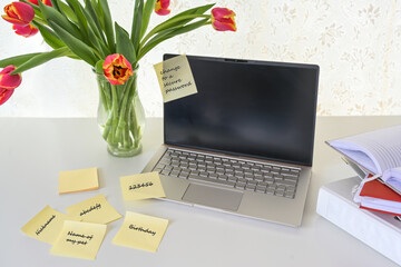 Computer security, laptop with various sticky password notes on a white desk, concept for safety in home office, business or study, copy space, selected focus