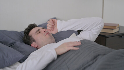 Man Coughing while Sleeping in Bed