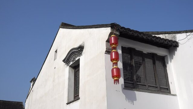 Lanterns hang on the wall in an ancient Chinese town
