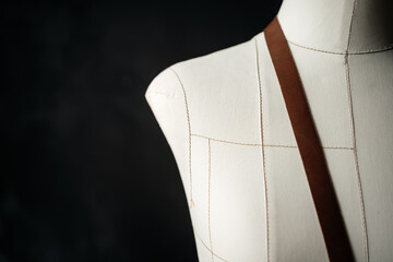 Brown leather belt on mannequin. The background is dark.
