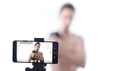 Sexy male coaching influencer video recording bodybuilding fitness exercise