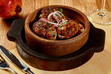 Lamb kebab with grilled eggplant, fresh onion, greens and pomegranate seeds