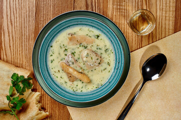 Creamy chicken chikhirtma soup with shotis puri and glass of chacha