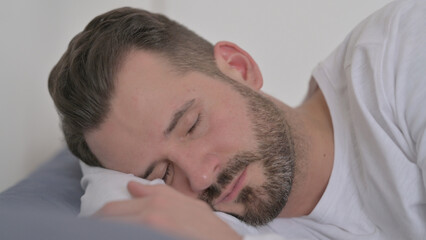 Fototapeta na wymiar Man Sleeping in Bed Peacefully