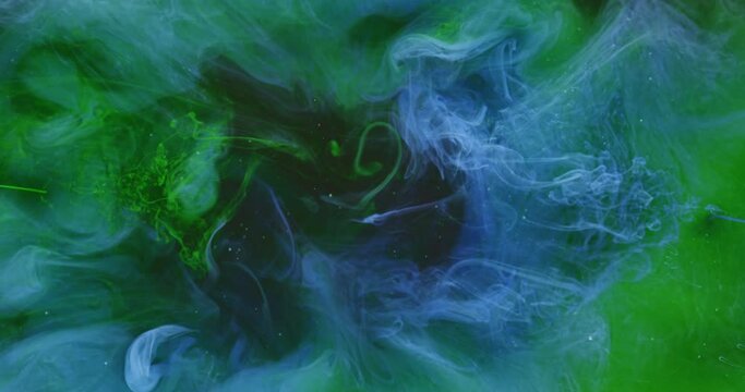 Color fluid mix. Smoke cloud motion. Logo opener effect. Green blue ink drop on bright purple fog texture abstract background shot on Red Cinema camera 6k.