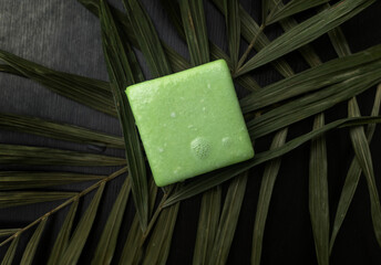 Solid hair shampoo. Composition of golden curls, soap suds, solid shampoo and comb. The concept of female care for long hair.