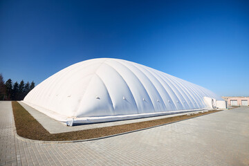 Inflatable air dome stadium. Inflated Tennis air dome or Tennis bubble arena. Modern urban architecture example as pneumatic stadium dome.