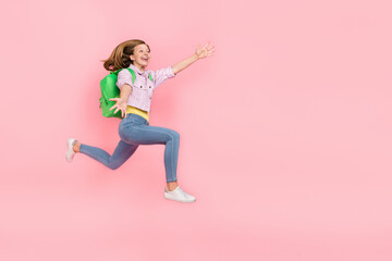 Fototapeta na wymiar Profile photo of surprised funky lady jump catch empty space wear backpack jacket isolated pink color background