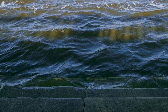 Bank of the Dnieper River. Waves hit the rocky shore