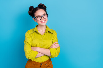 Photo of creative minded lady representative cross arms look empty space working ads isolated blue color background