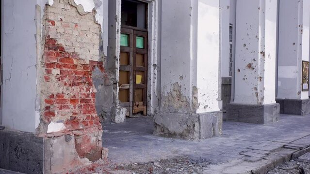 Damaged ruined civilian building in ukrainian city Chernihiv near Kyiv on north of Ukraine. Ruins during War of Russia against Ukraine in 2022. Walls, broken windows of buildings. Aircraft, artillery