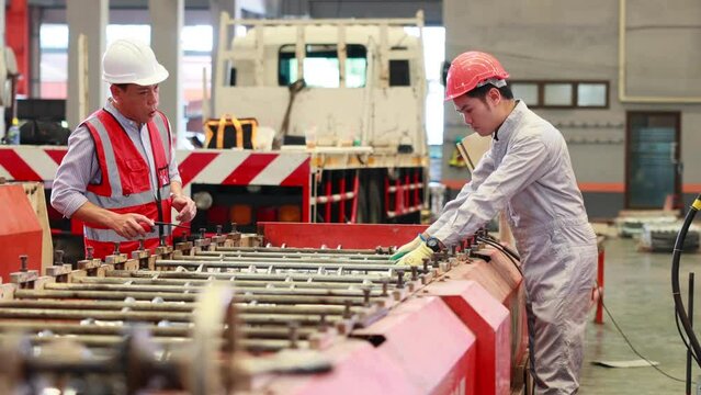 Factory engineer worker operating metal sheet roof machine at Heavy Industry Manufacturing Factory. worker in safety hardhat at factory industrial facilities