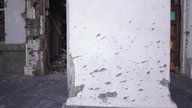 Damaged ruined civilian building in ukrainian city Chernihiv near Kyiv on north of Ukraine. Ruins during War of Russia against Ukraine in 2022. Walls, broken windows of buildings. Aircraft, artillery