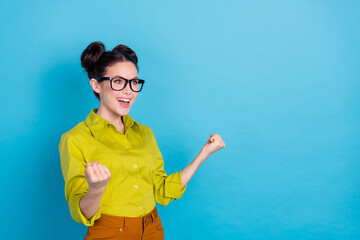 Photo of delighted lady ceo agent celebrate start up invention fist up empty space isolated blue color background