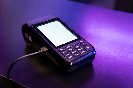 Credit card reader or pos terminal with copy space on the screen in a supermarket. concept of mobile payment.