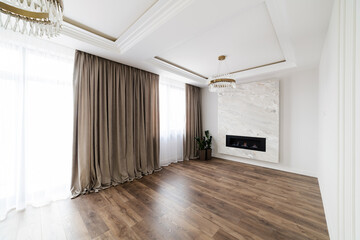 interior design of a white, new room with a fireplace in the house