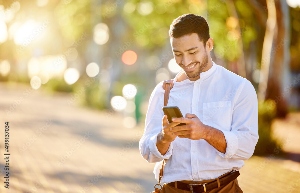 Poster making those after-work plans. shot of a handsome young businessman standing alone in the city and u