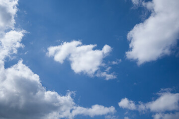 Naklejka na ściany i meble White fluffy clouds in blue sky.