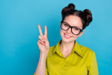 Portrait of optimistic real estate ceo agent lady make v sign symbol isolated on blue color background