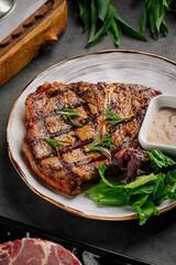 Top view on grilled beef steak with pepper sauce