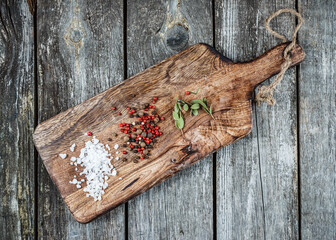 Dry spices on a wooden cutting board in a rustic style