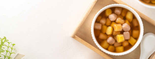 Delicious sweet taro ball soup in a white bowl for serving.